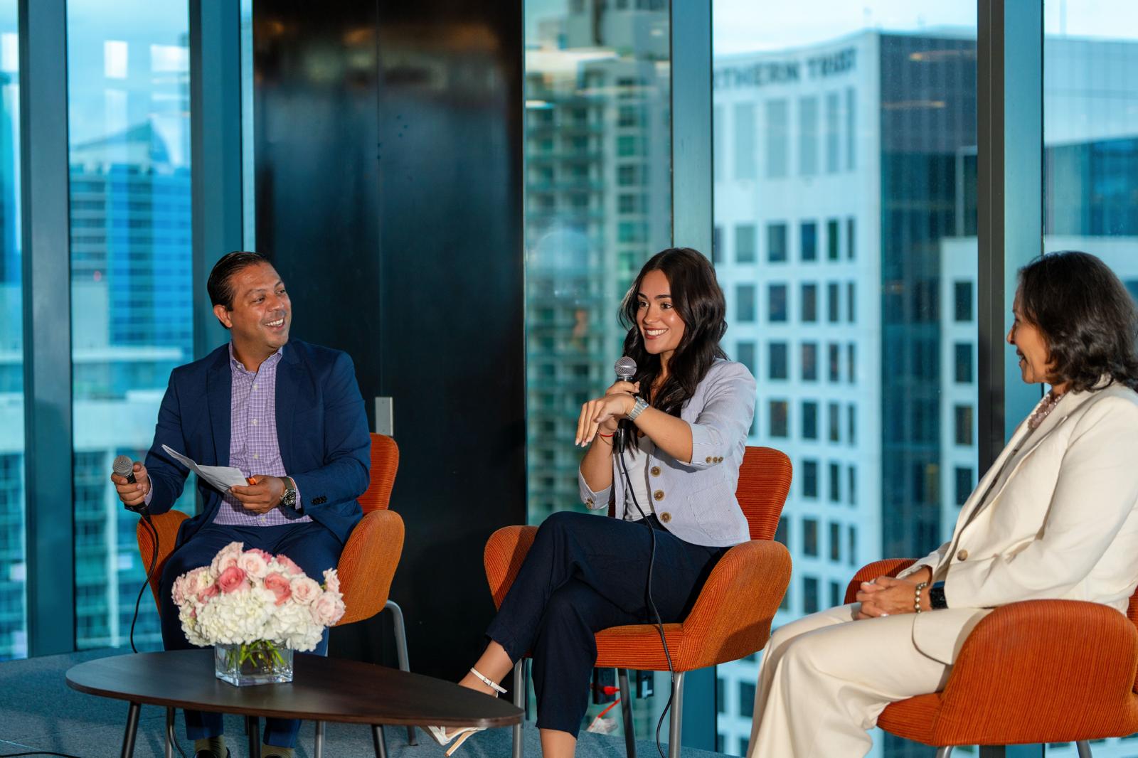 Maite speaking on a panel in Miami